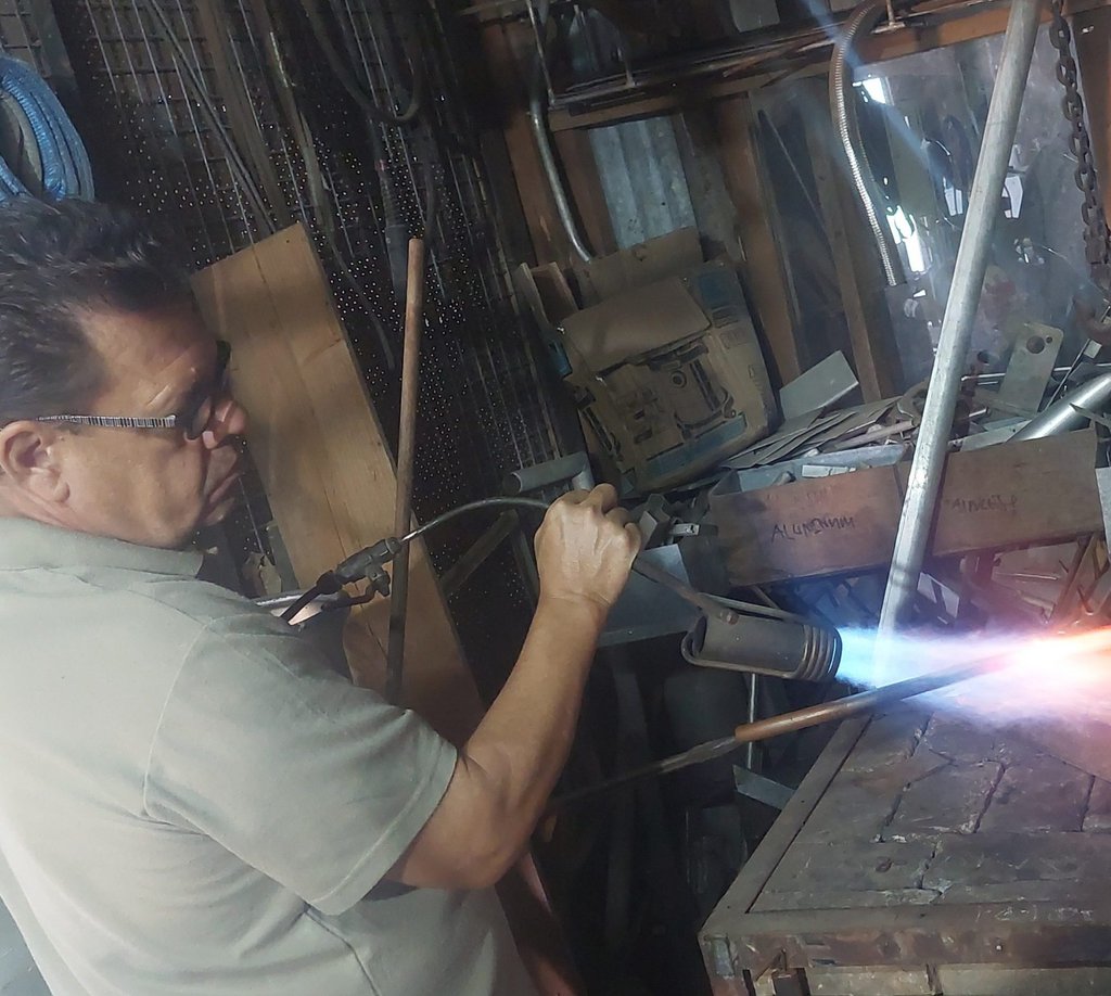 Metal artist Shane Bower at work in his studio in Savusavu