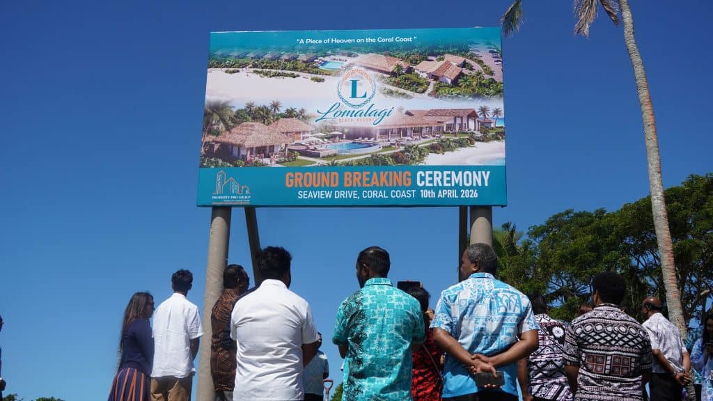 people with backs to the camera look at a signboard